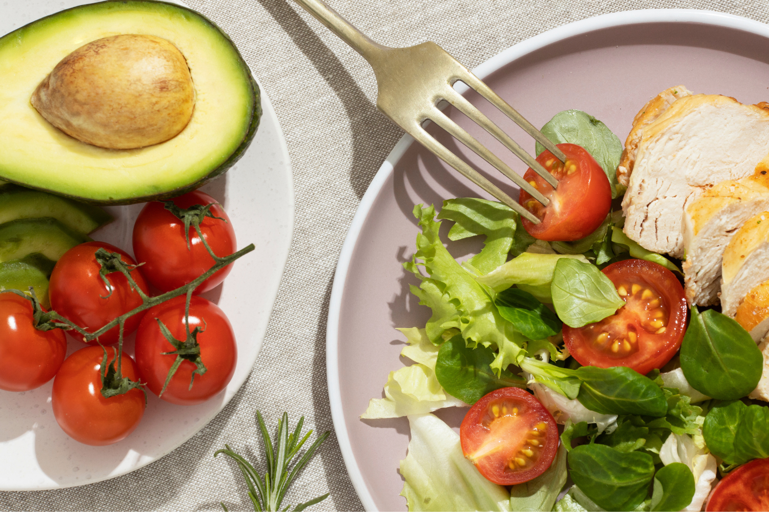 Plate of greens with tomatoes, avocado and chicken