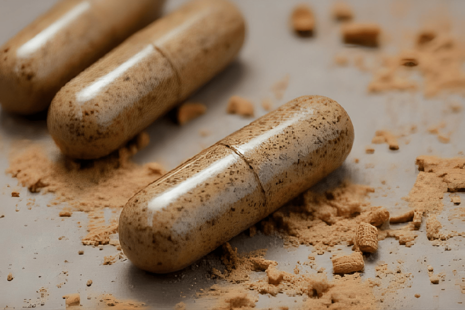 Natural supplement capsules with powdered herb spills
